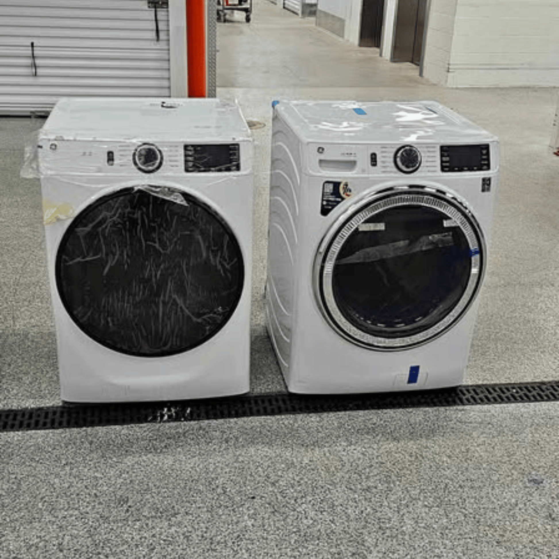 Brand new GE front load washer and dryer set, white, side by side view