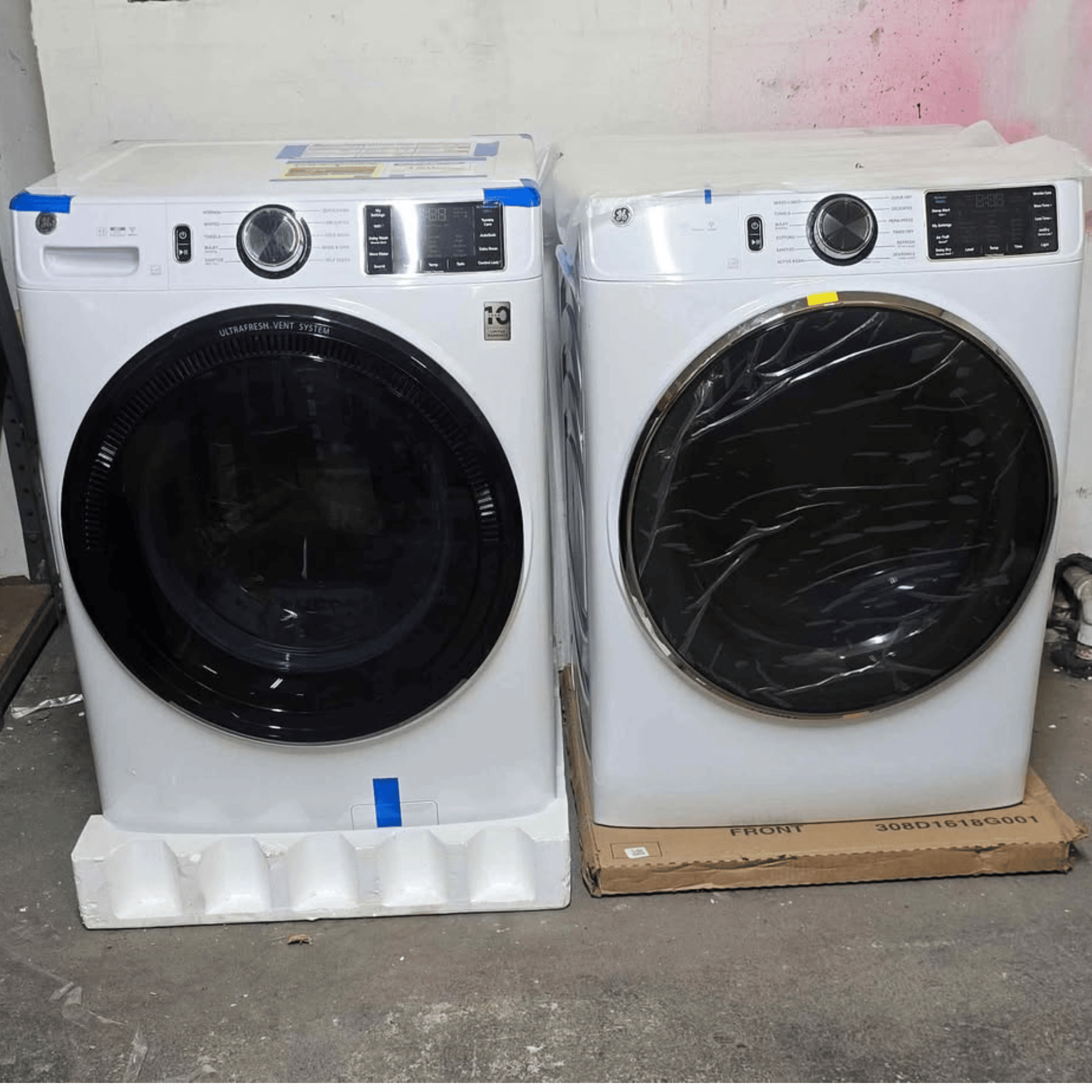 Brand new GE front load washer and dryer set, white, side by side view
